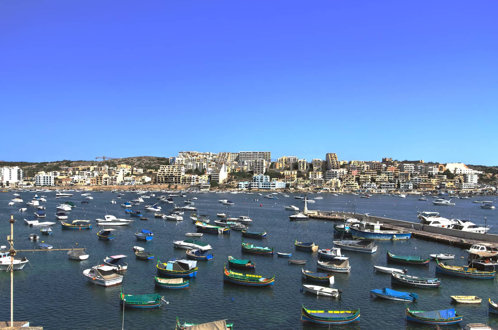 Fishing harbour in the St Paul's Bay and panorama of Xemxija in the background - San Pawl il-Baħar, Malta