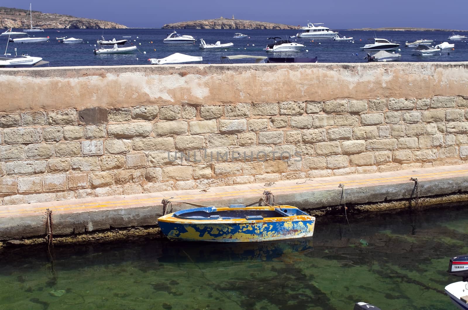 Boat in the boat shelter in the old part of fishing village of St Paul's Bay - San Pawl il-Baħar, Malta