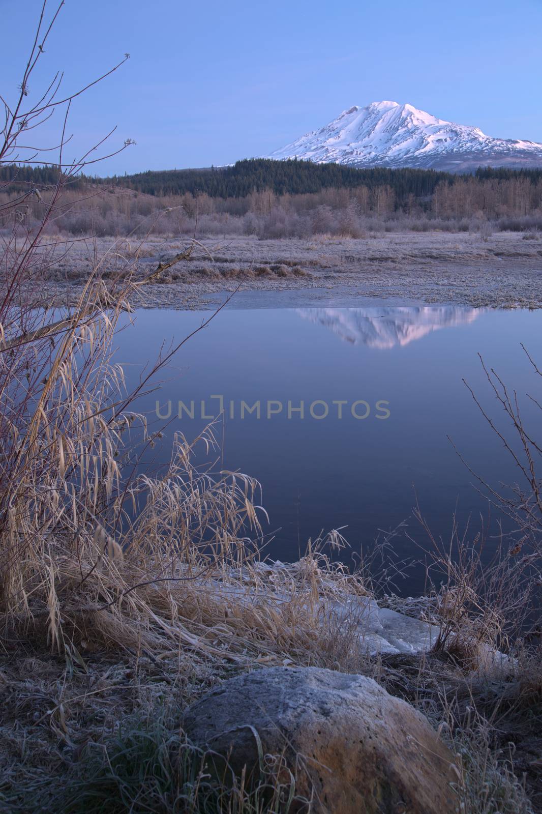 An amazing still lake scene in front of Mount Adams Washington