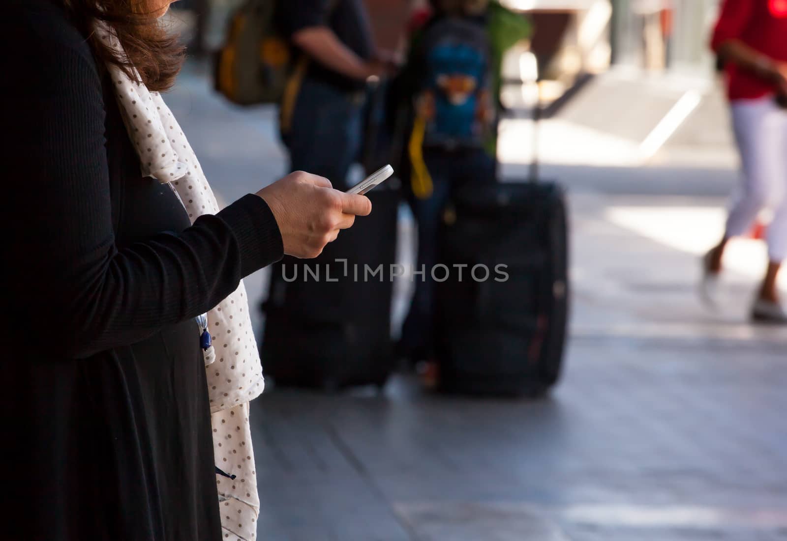 Woman with phone in the railway station