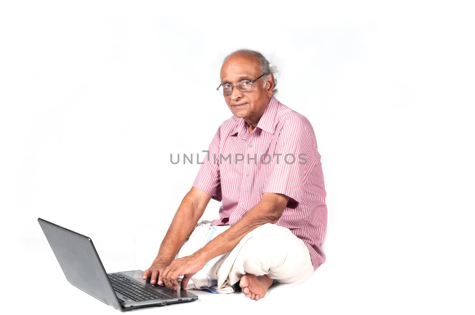 an old Indian man surfing the net after retirement