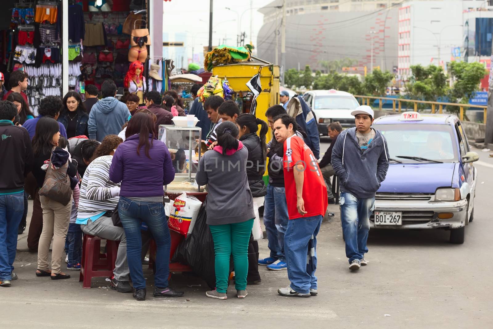 LIMA, PERU - JULY 21, 2013: Unidentified people around a food stand at the mall Polvos Azules on the Av. Paseo de la Republica on July 21, 2013 in the center of Lima, Peru.