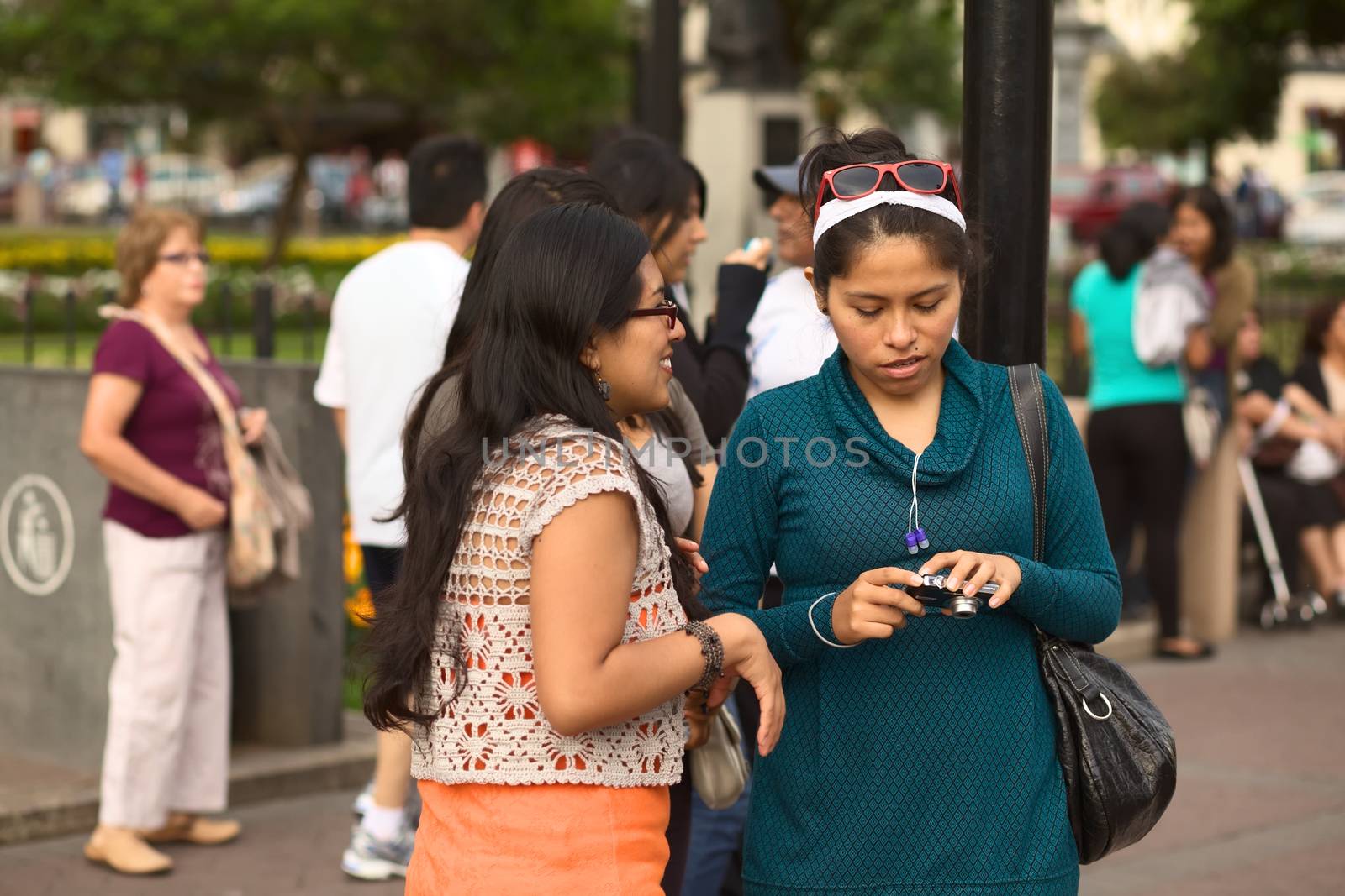 LIMA, PERU - MARCH 3, 2012: Unidentified youg woman looking at a camera on March 3, 2012 in Miraflores, Lima, Peru