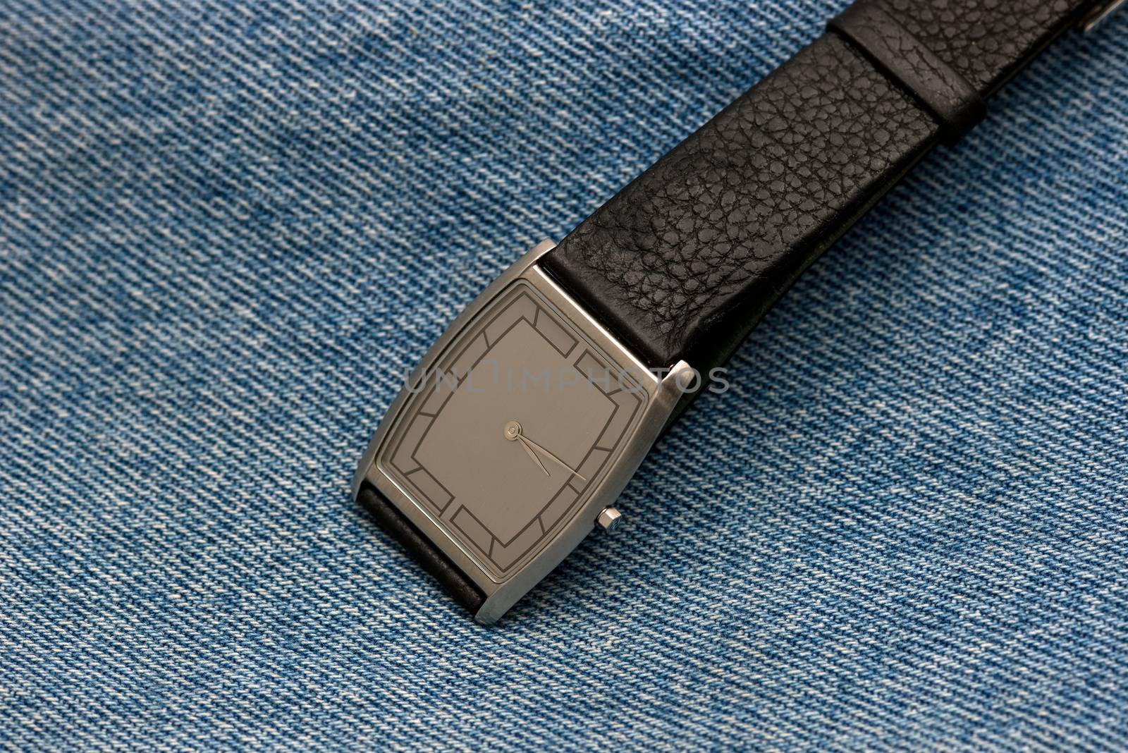 wrist watch on a background made from close up of texture in jeans