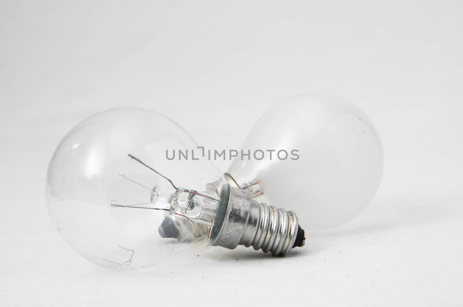 Two Different Old Incandescent Light Bulbs on a White Background