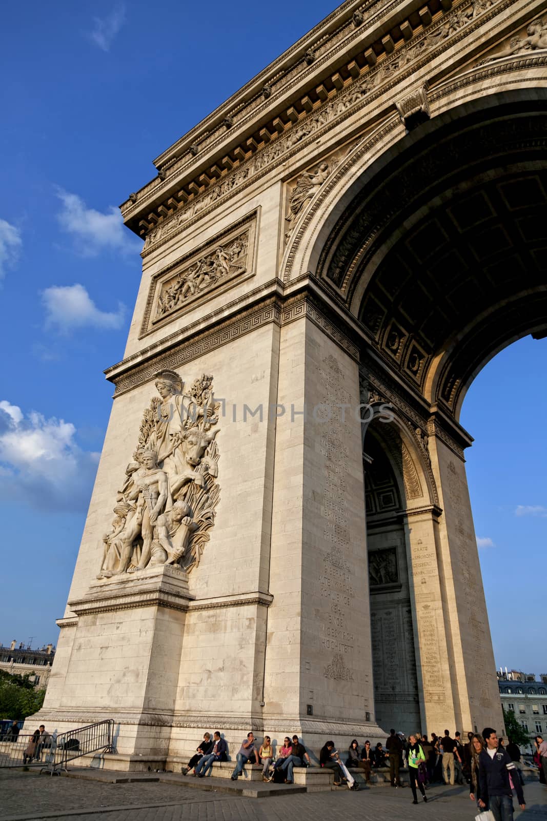 A fragment of Arc de Triumph in Paris, on a blue sky