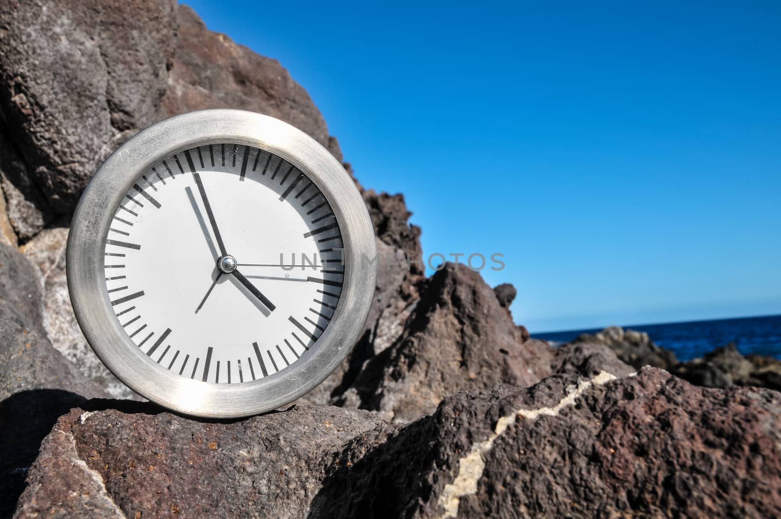 Time Concept Alarm Clock on the Volcanic Rocks