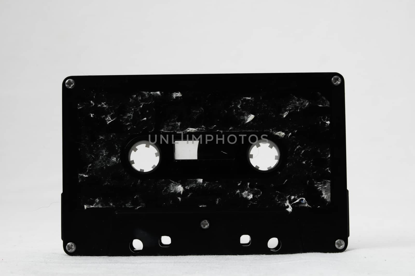 Ancient Vintage Used Musicassette over a White Background