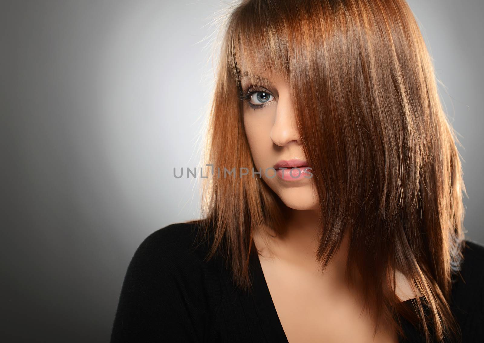 Beautiful young woman over grey background