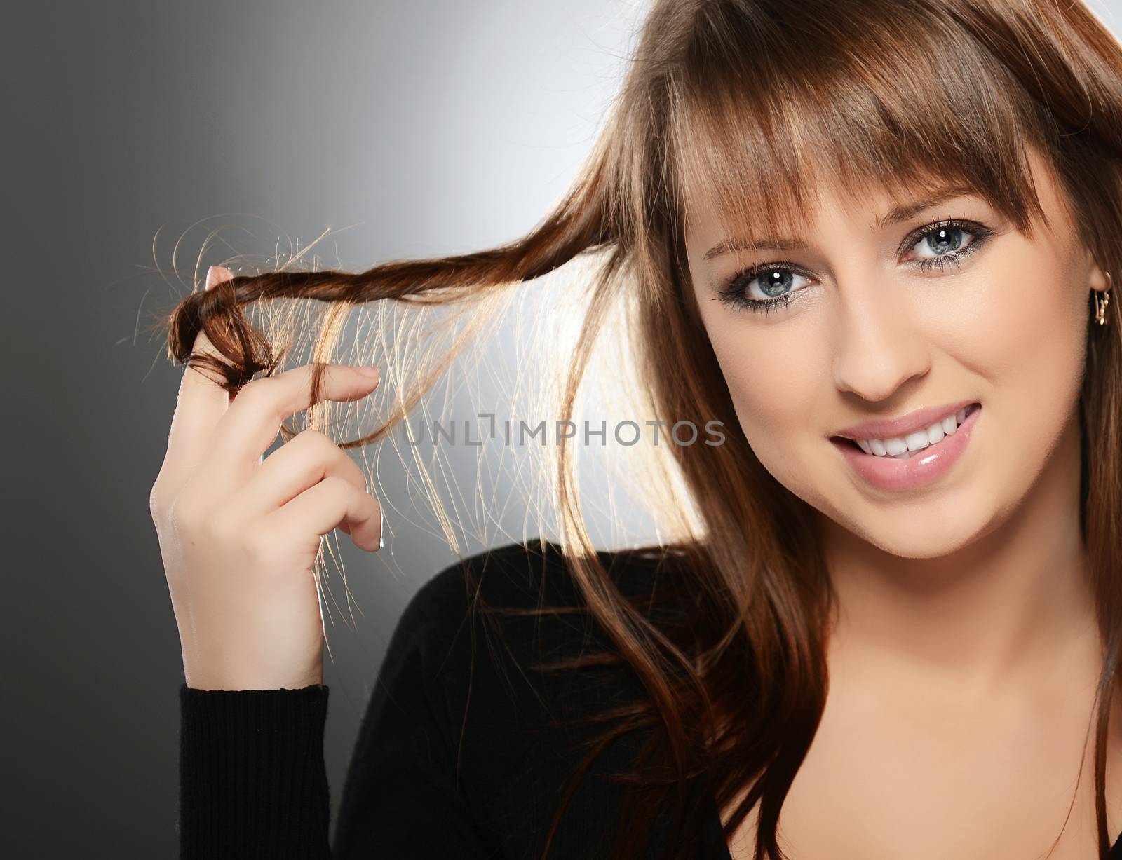 Beautiful young woman over grey background