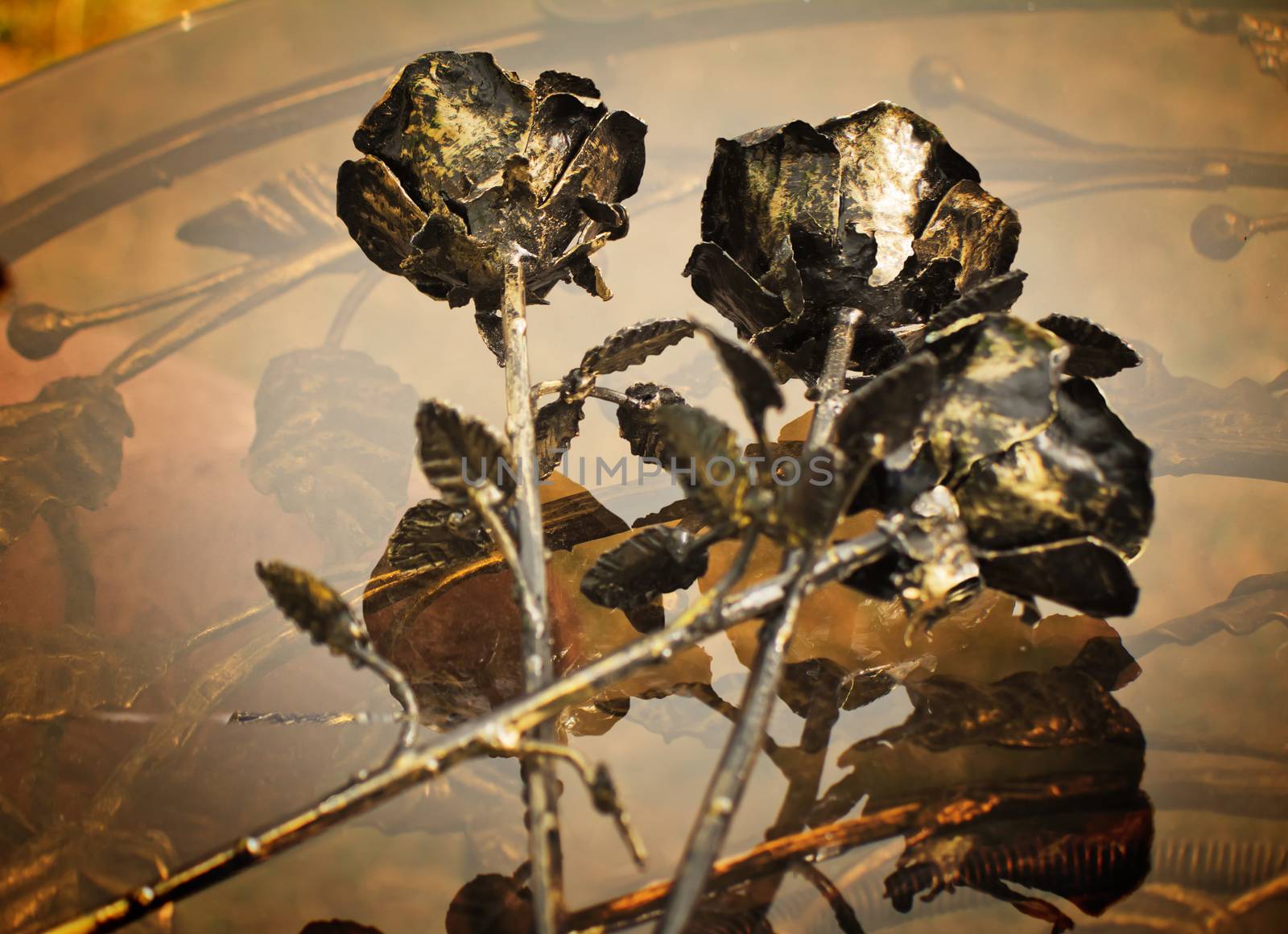 Three pretty shiny Golden rose, forged from metal. Manual work.