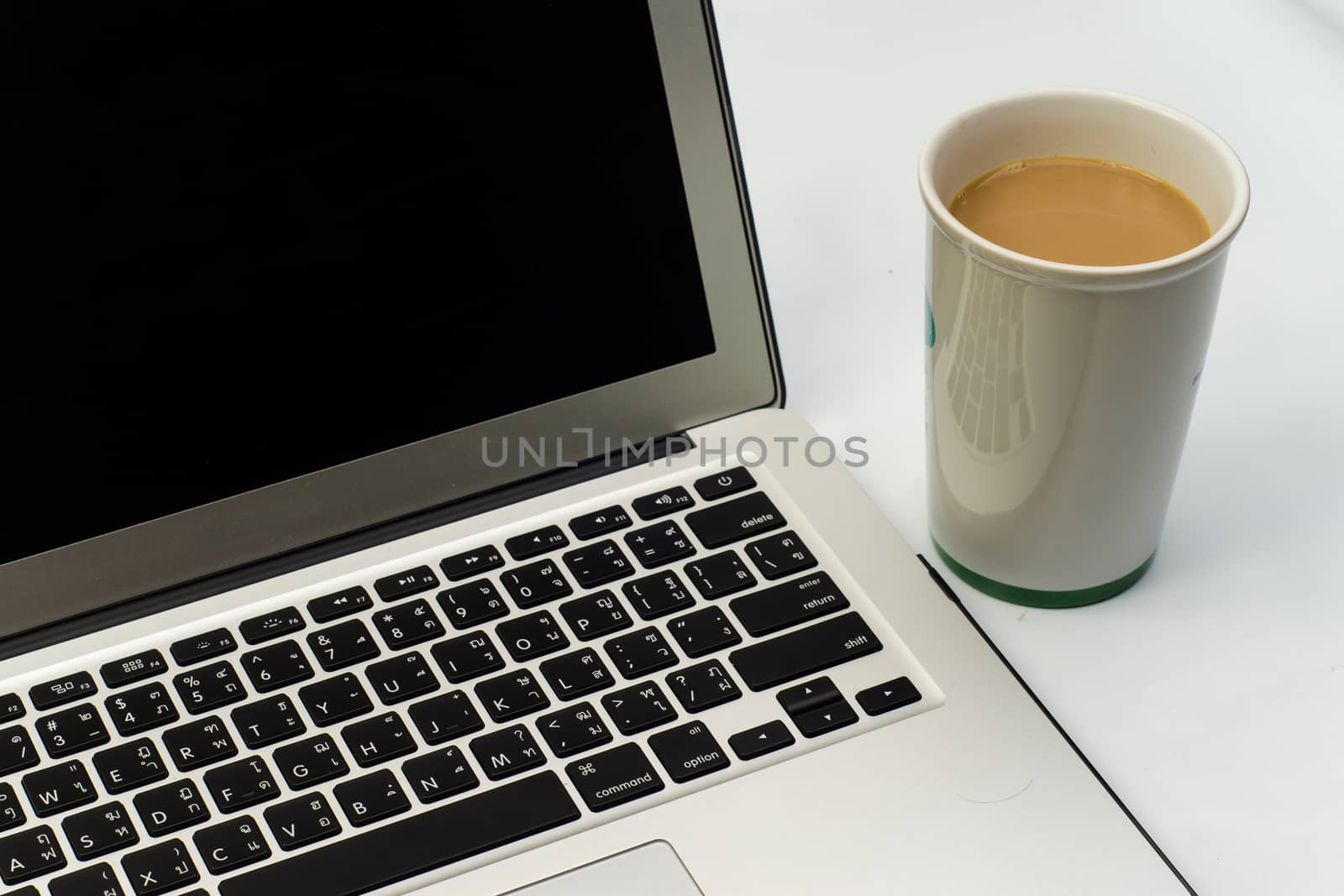 White desk with laptop computer and cup of coffee with bread by themorningglory