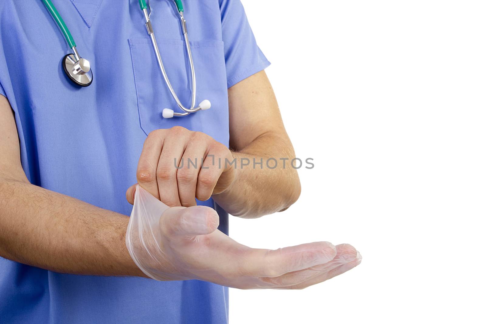 The doctor puts on latex gloves on his hands.