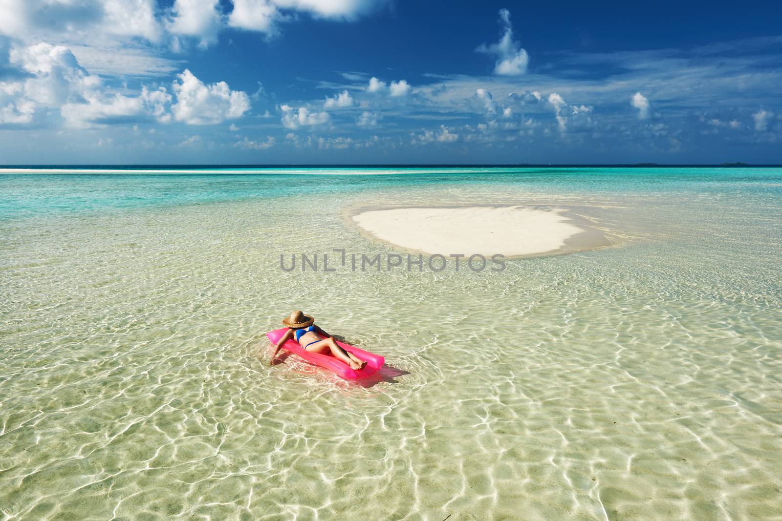 Woman relaxing on inflatable mattress by haveseen