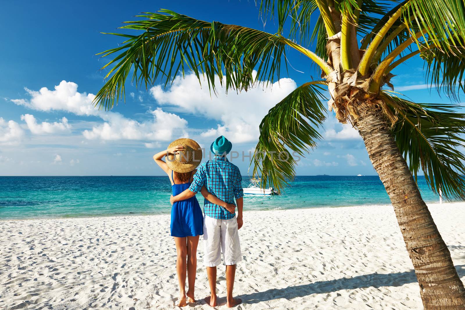 Couple in blue clothes on a beach at Maldives by haveseen