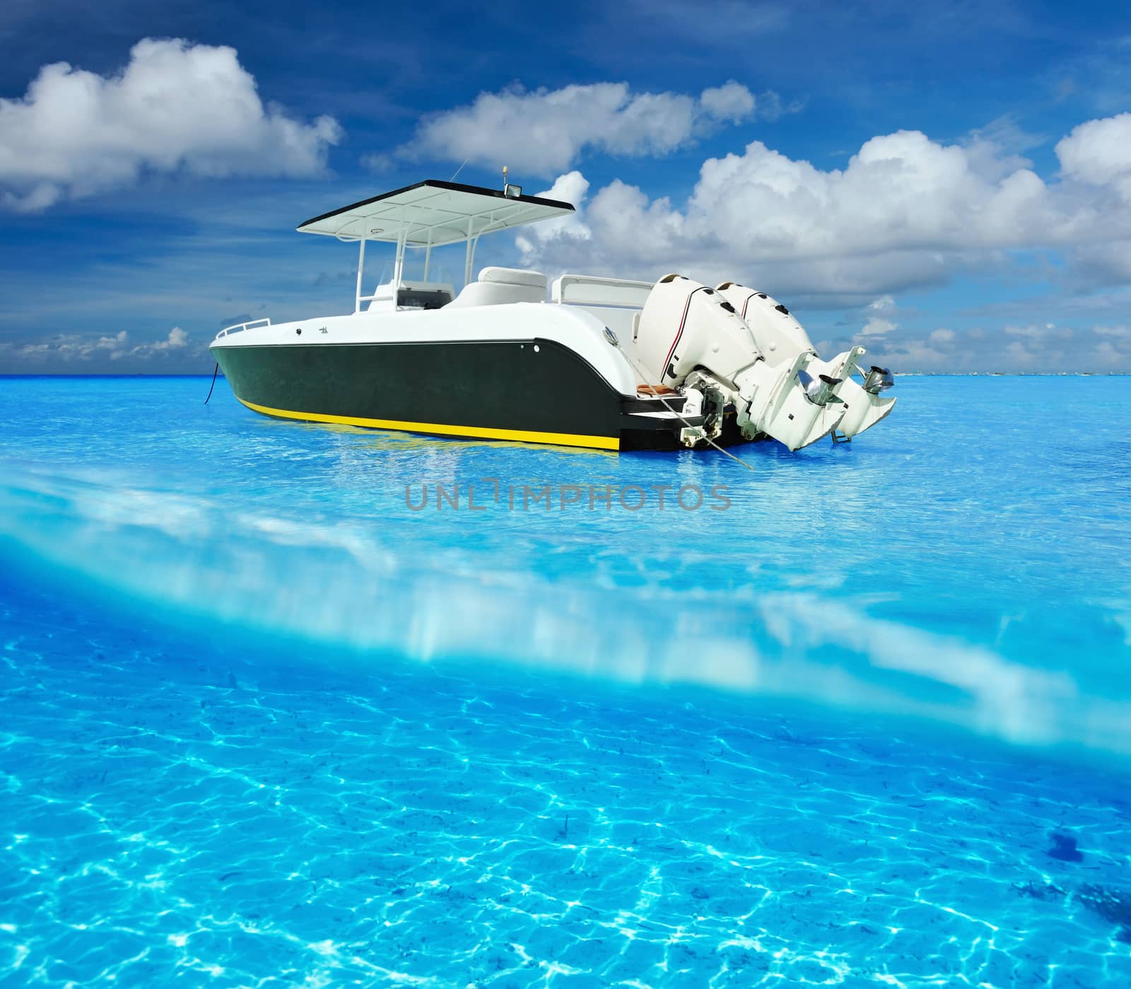 Beach and motor boat with white sand bottom underwater view by haveseen