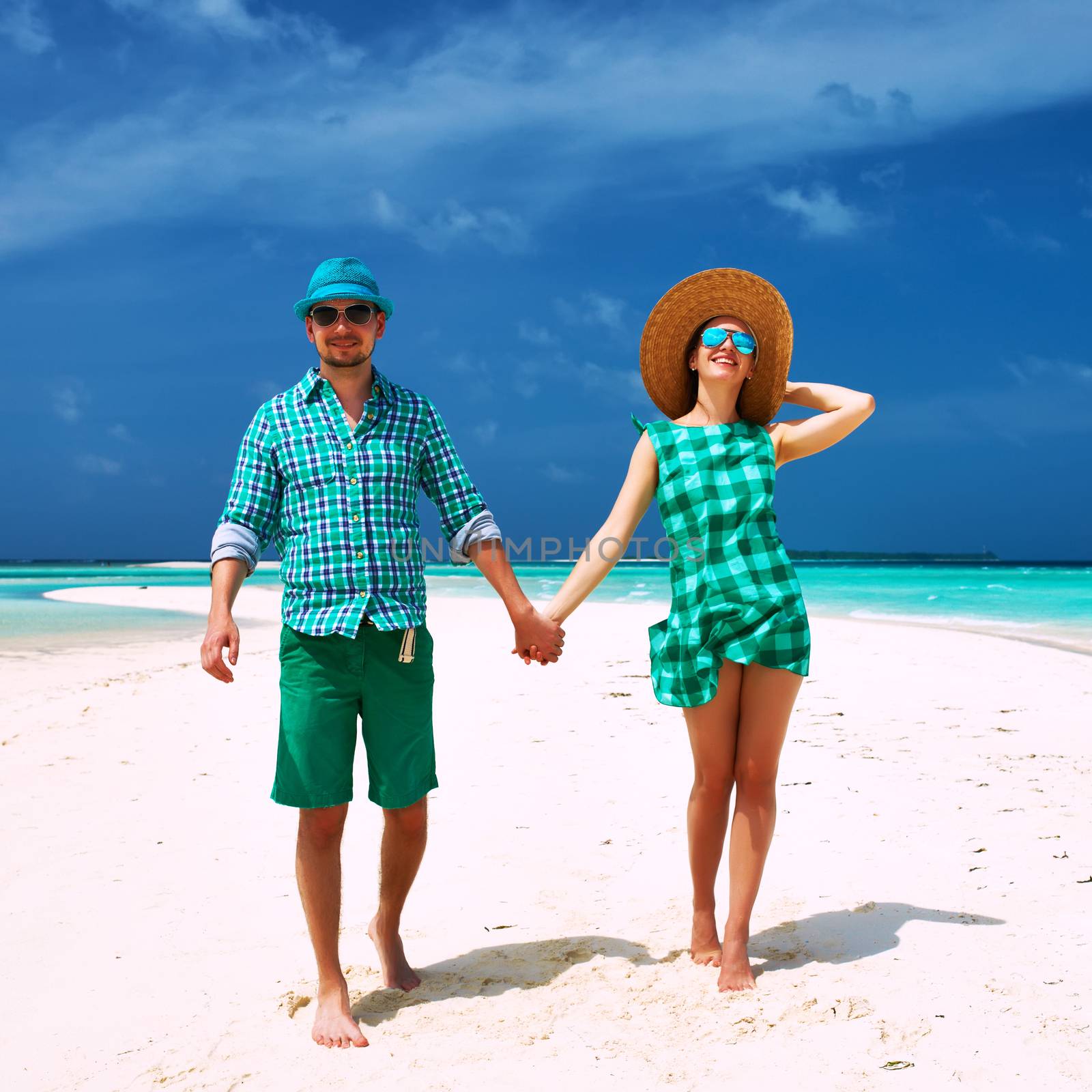 Couple in green on a tropical beach at Maldives