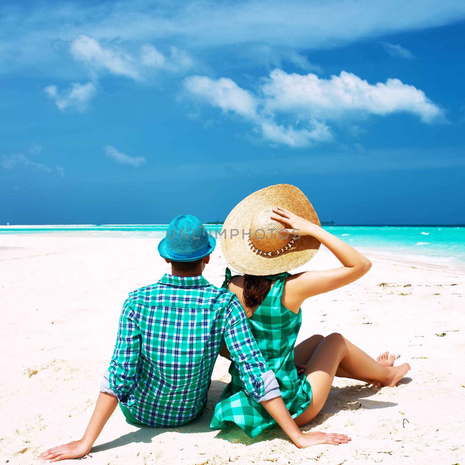 Couple in green on a tropical beach at Maldives