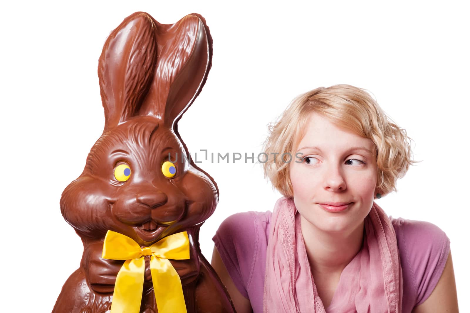 Chocolate Easter Bunny and a Blond Girl Looking at each other. Isolated Over White