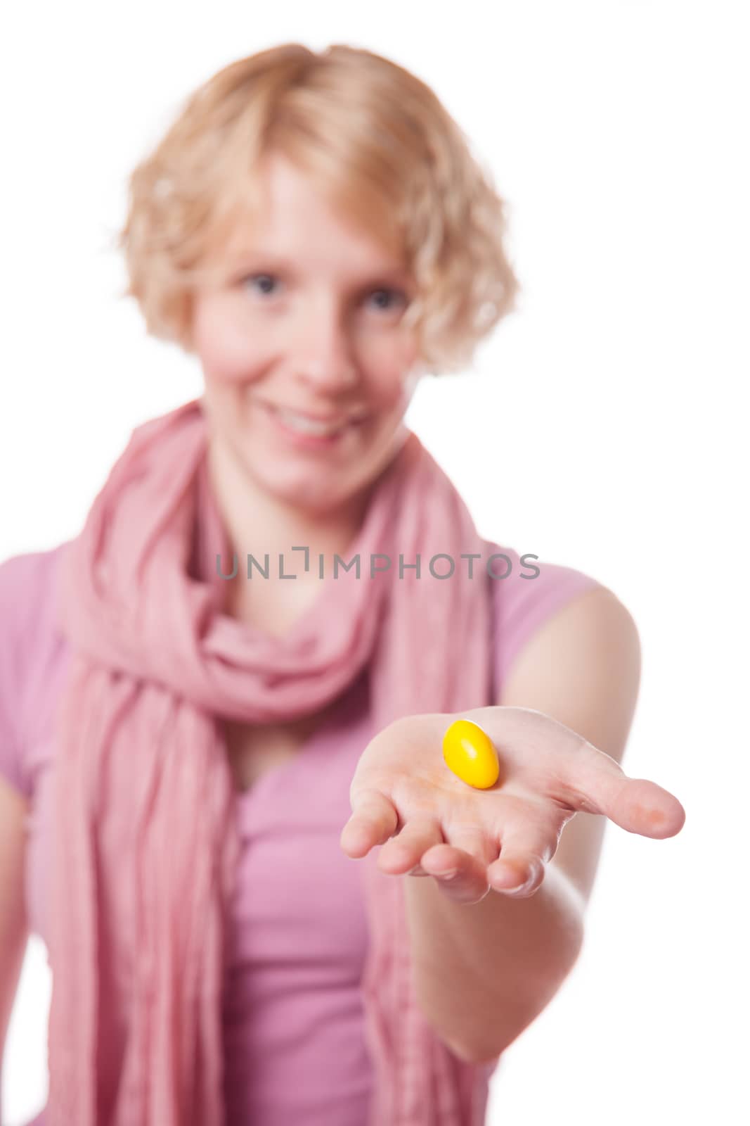 Young Woman Holding a Yellow Easter Egg in front of the Cameras - Isolated on White Background