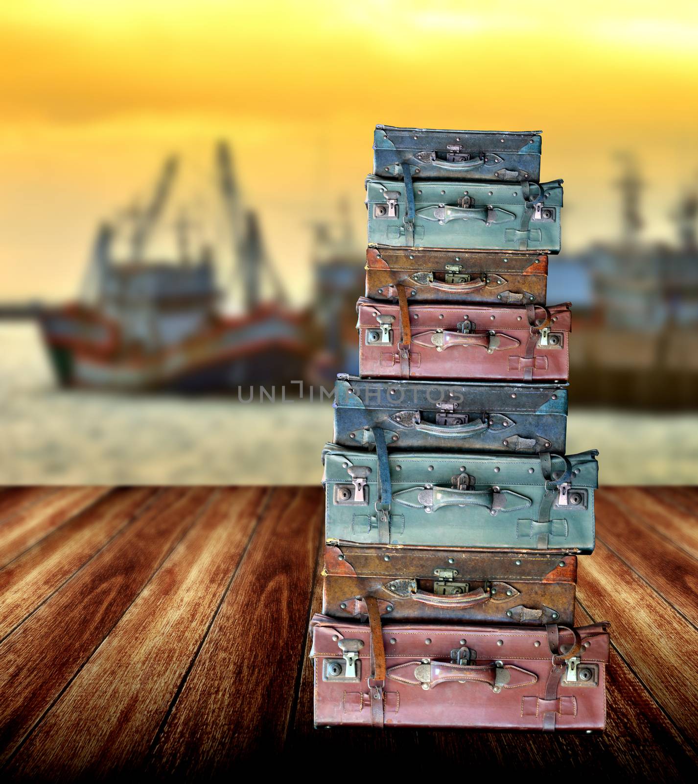 Luggage for travel on wooden floor beside the jetty