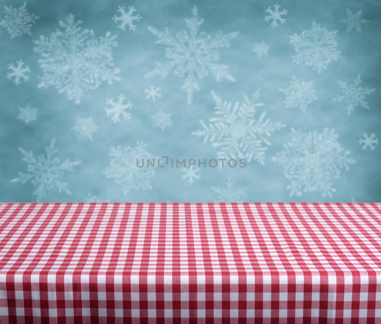 Empty table with red gingham tablecloth over blue background. Great for product display montages