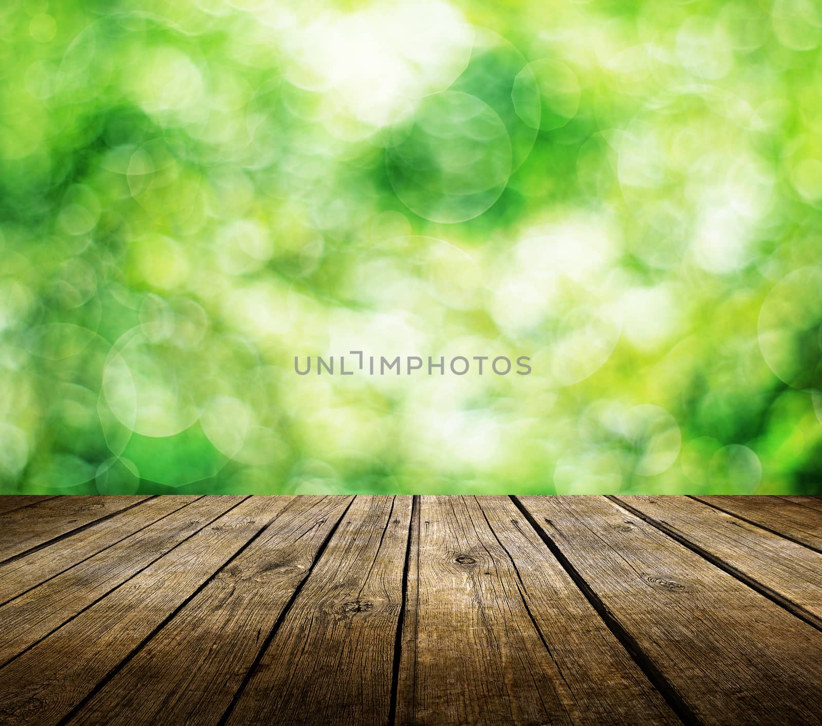 Wooden deck table over beautiful green background