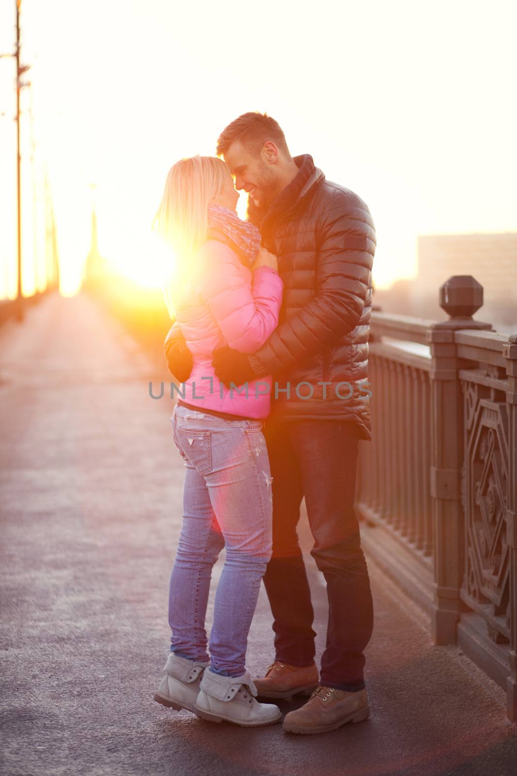 A pair of lovers are hugging and goodbying on the city bridge