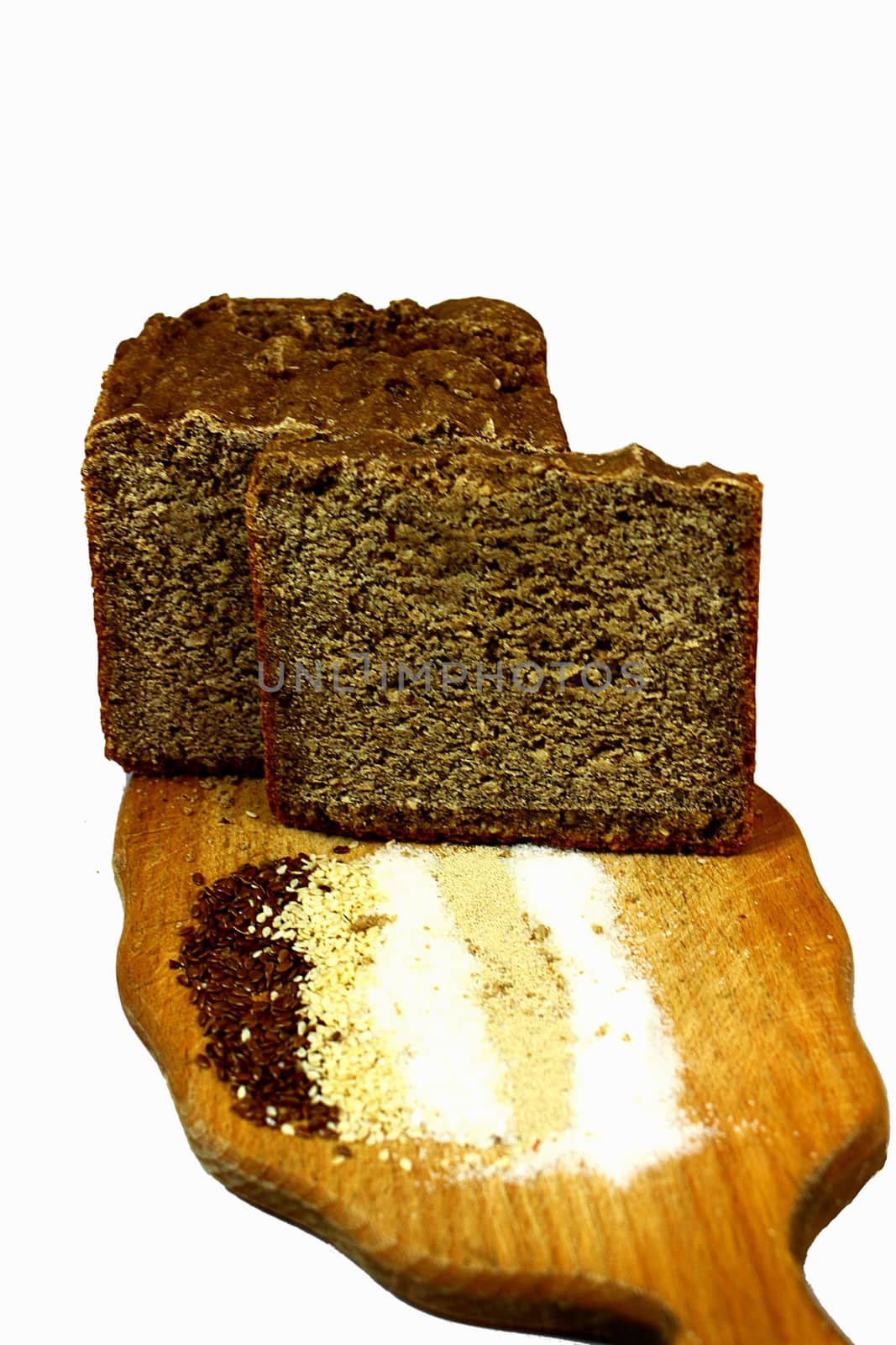 Board on a white background, it bread, flax seeds, sesame seeds, salt, sugar, yeast