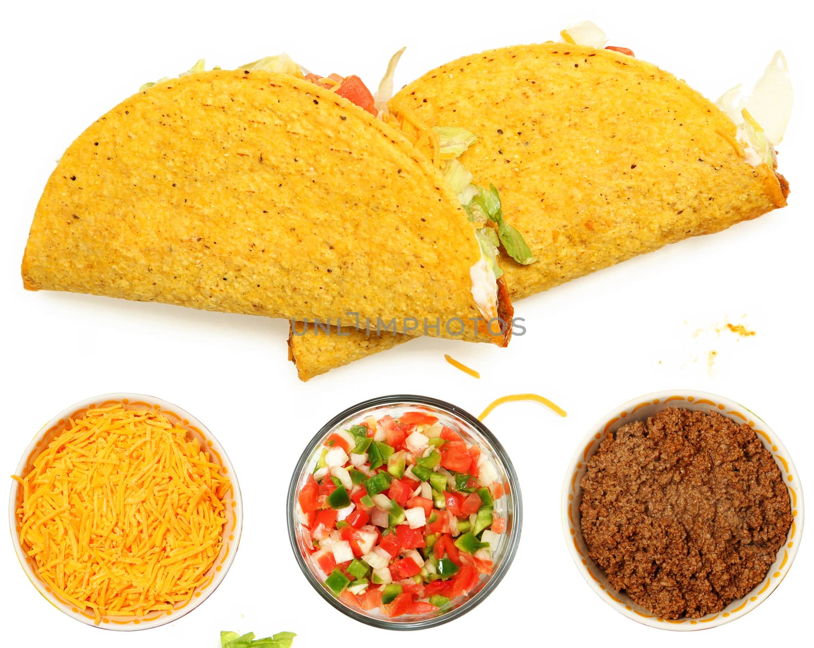 Two Tacos Stacked on White Background with cheese and lettuce. Bowl of cheese, trinity  and meat below.