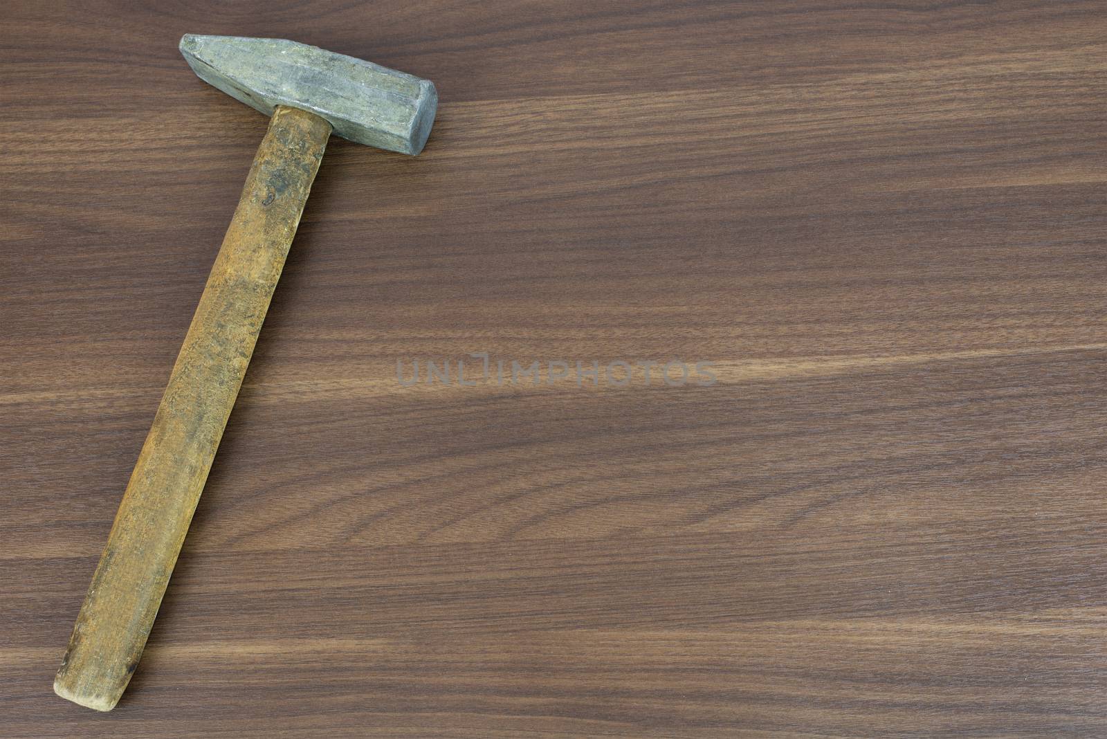 Old hammer on a wooden surface. carpenter tools