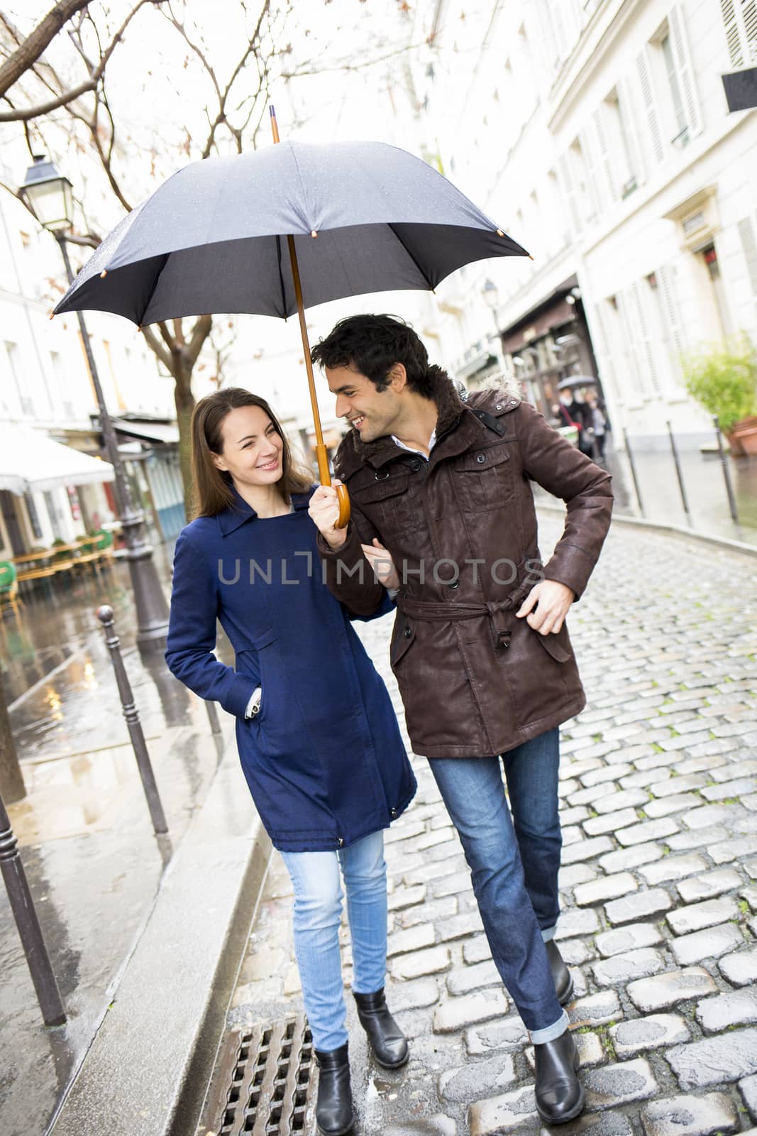 Happy  smiling woman man umbrella shower