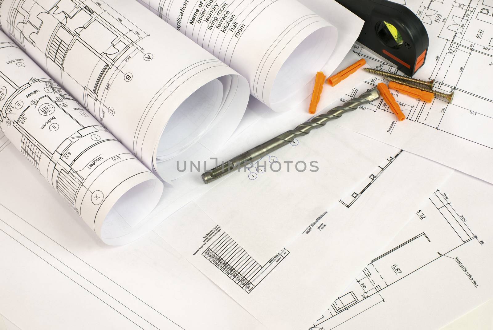 Construction drawings, drill, screws and level. Desk builder