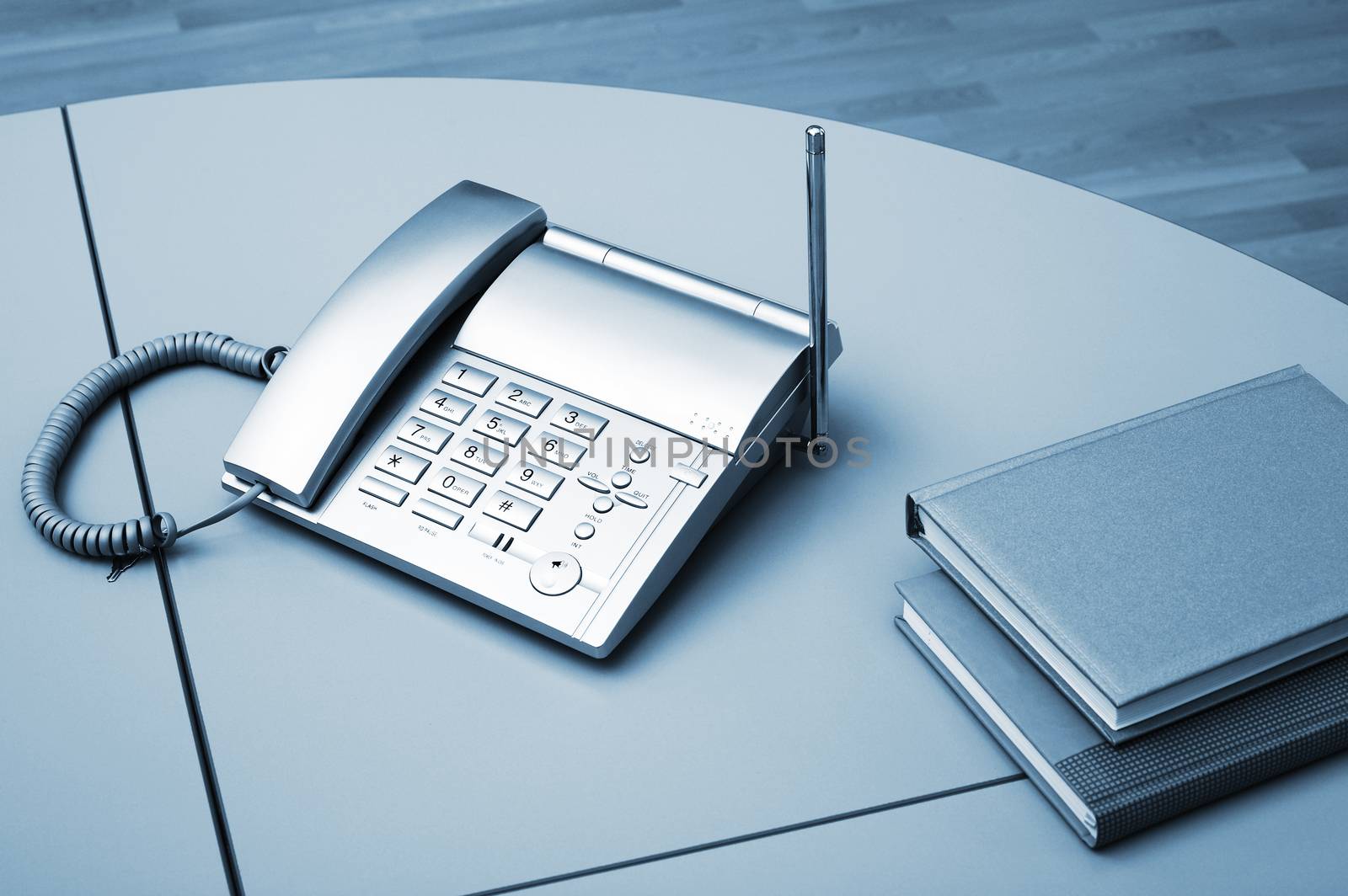 Phone and two books on a table at office