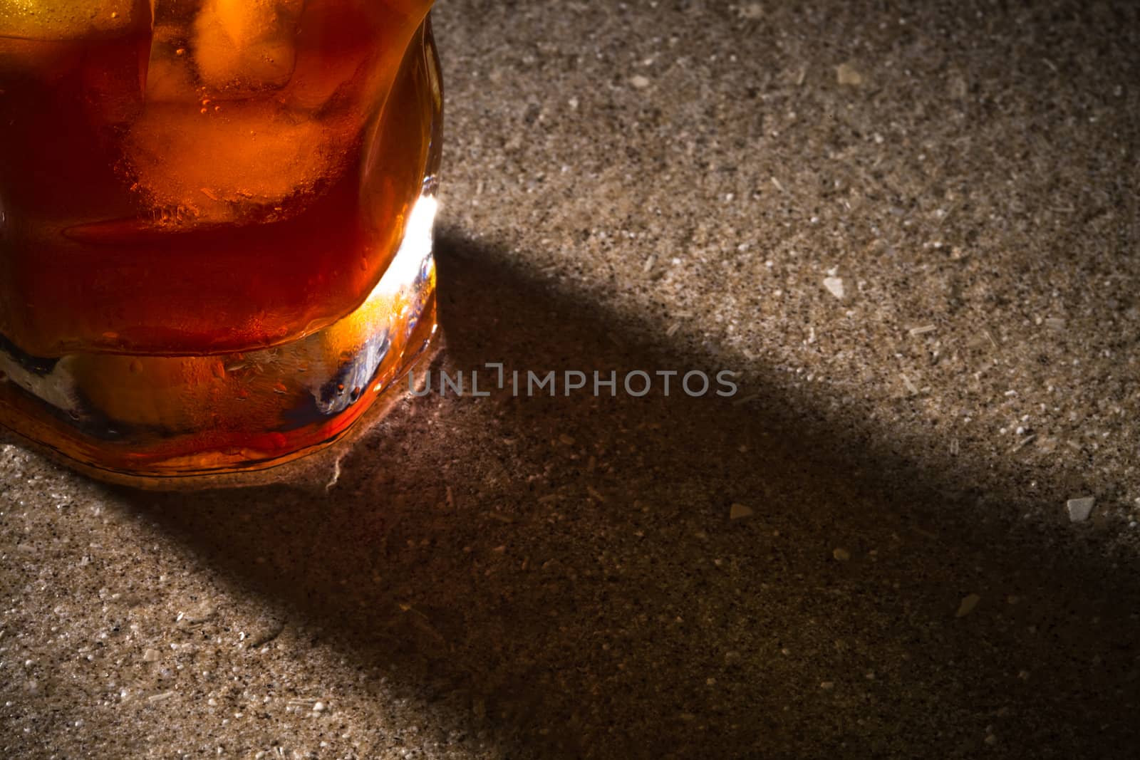 a glass of whiskey with a close-up on the marble table