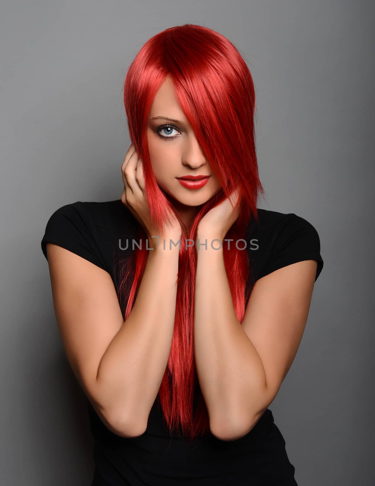 Beautiful red haired woman over gray background