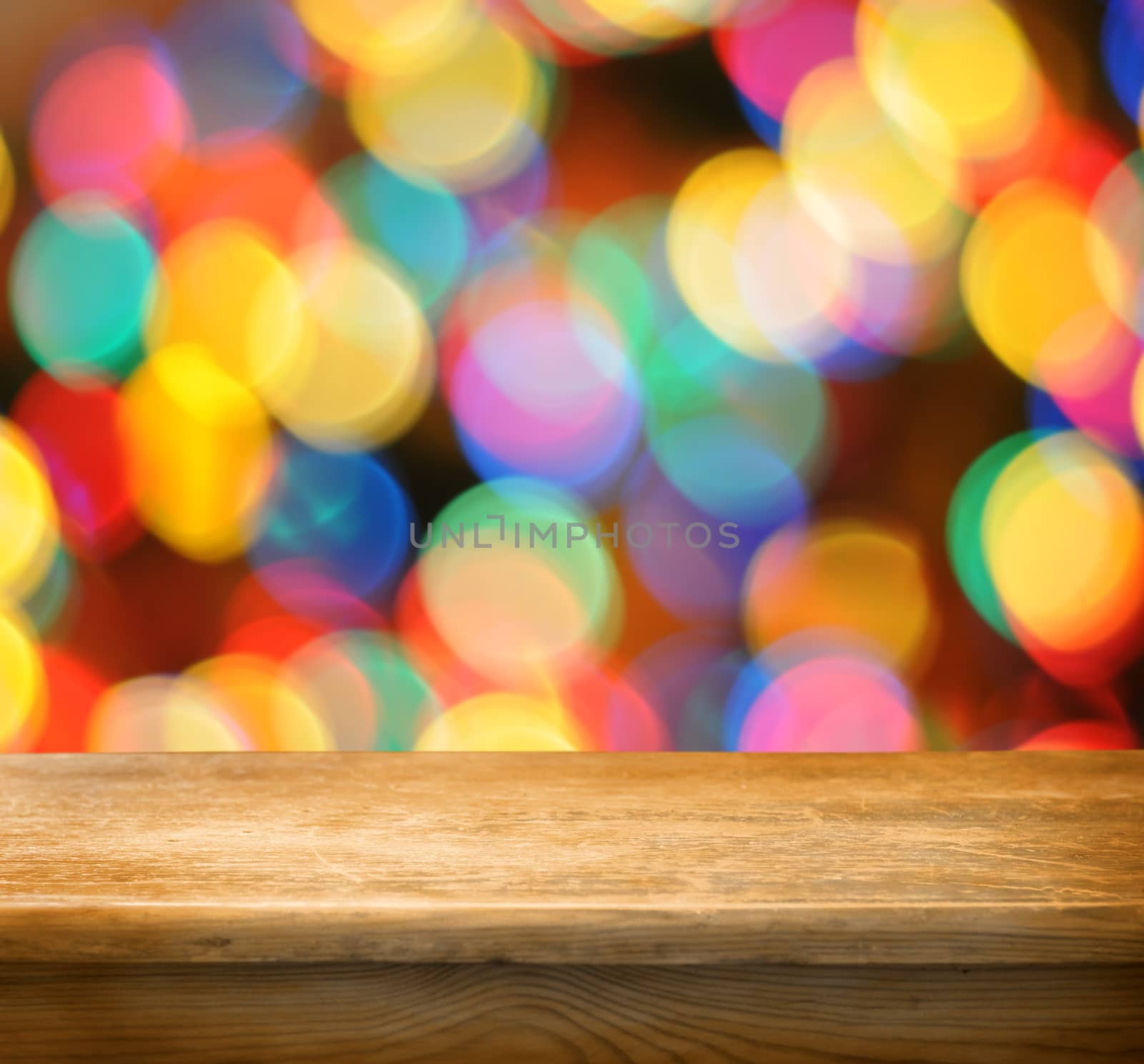 Empty wooden deck table with colorful bokeh background. Ready for product display montage.