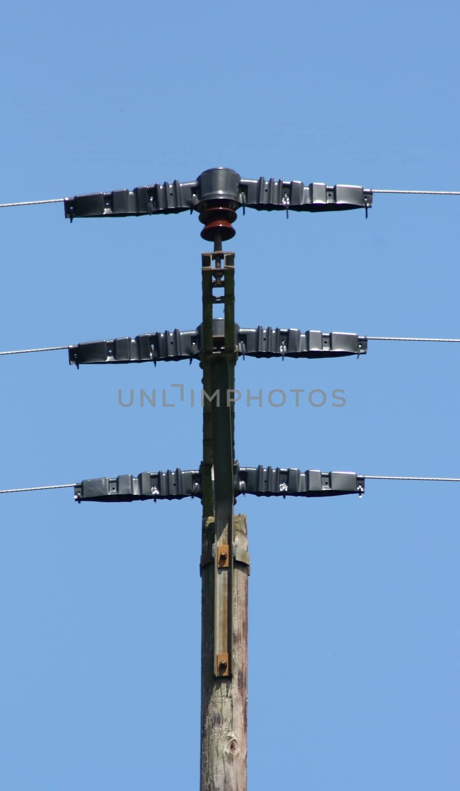 large transmission power pole, with blue sky background