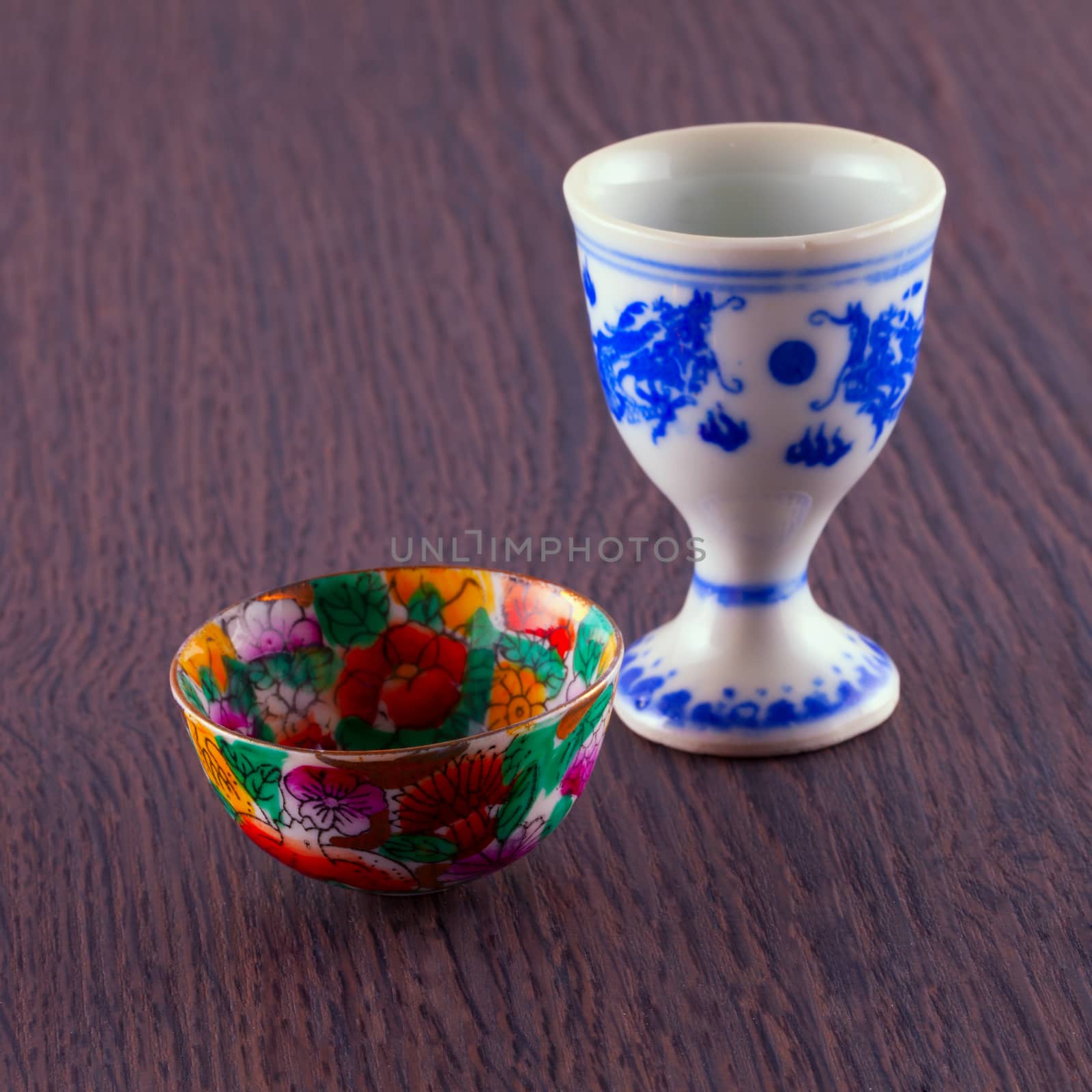 Small chinese cups for liquor, over wooden background