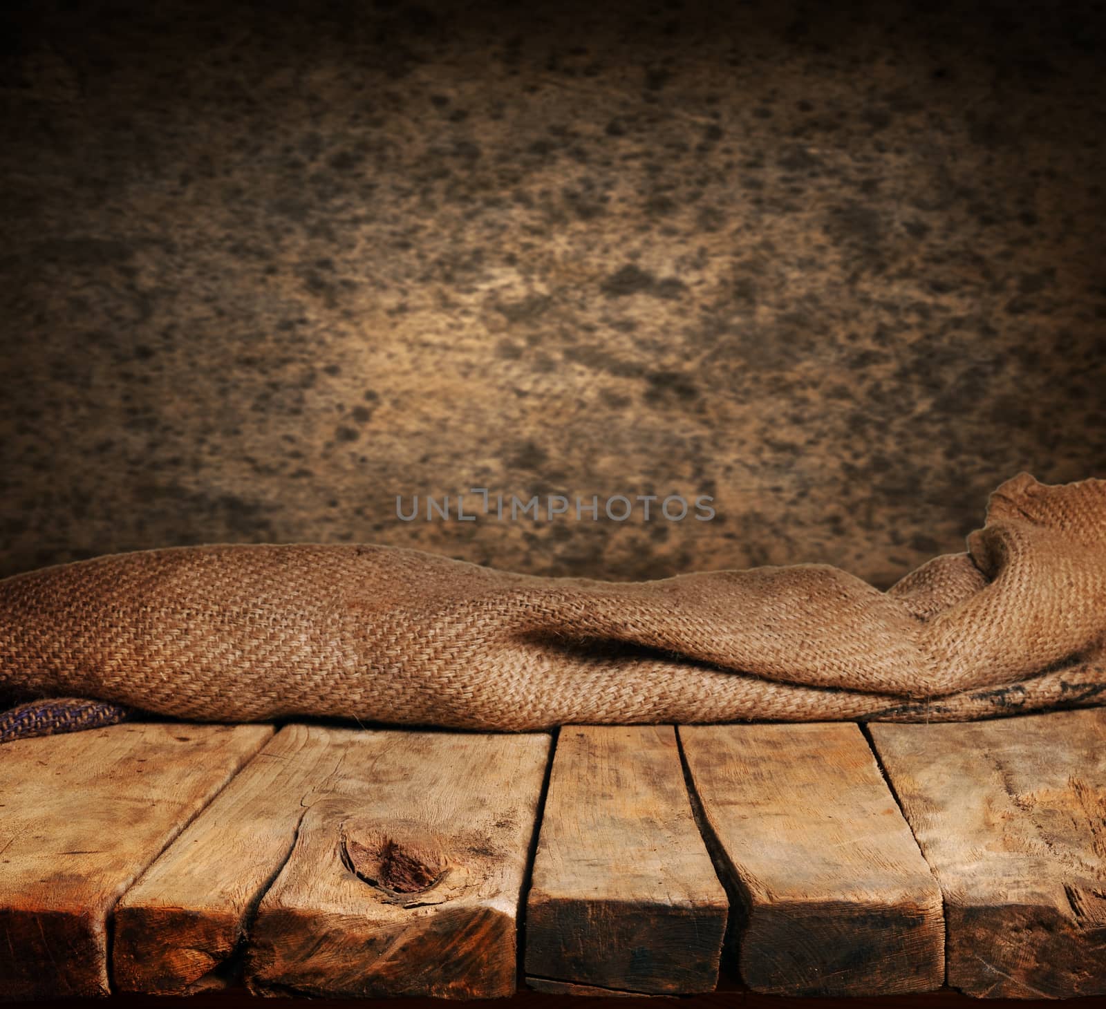 Empty wooden deck table with brown wall in background. Ready for product display montage.