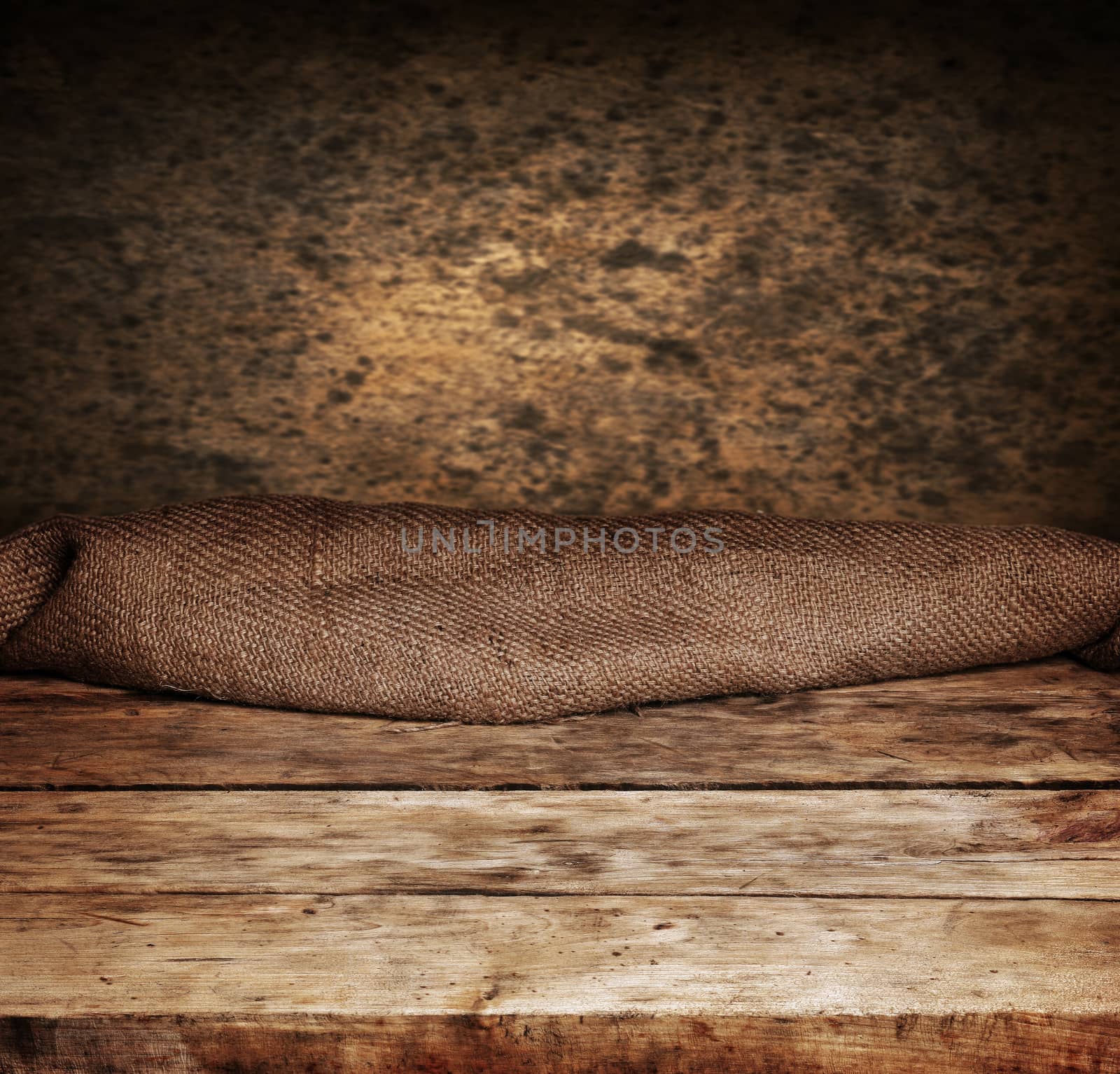 Empty wooden deck table with brown wall in background. Ready for product display montage.