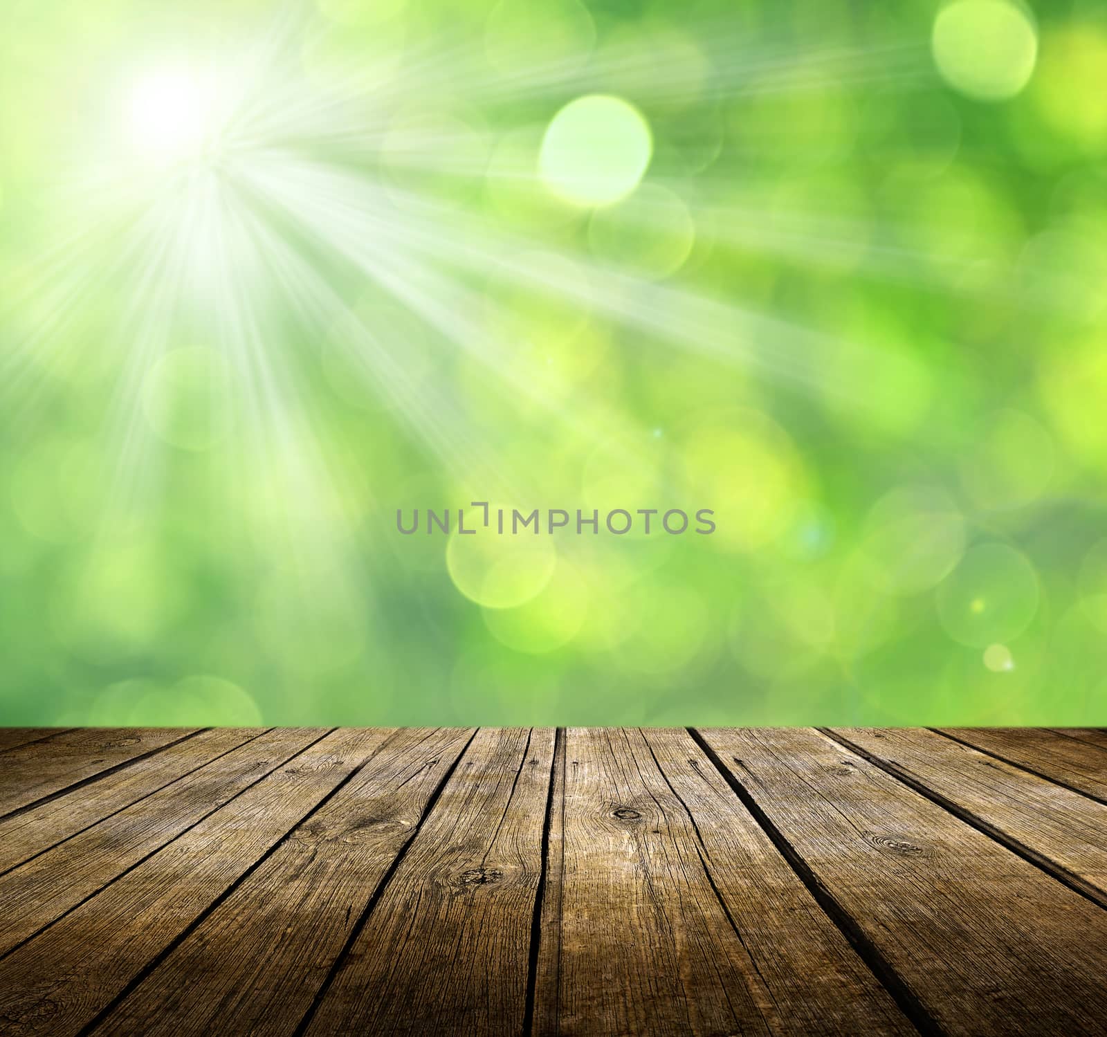 Empty wooden deck table with green background. Ready for product display montage.