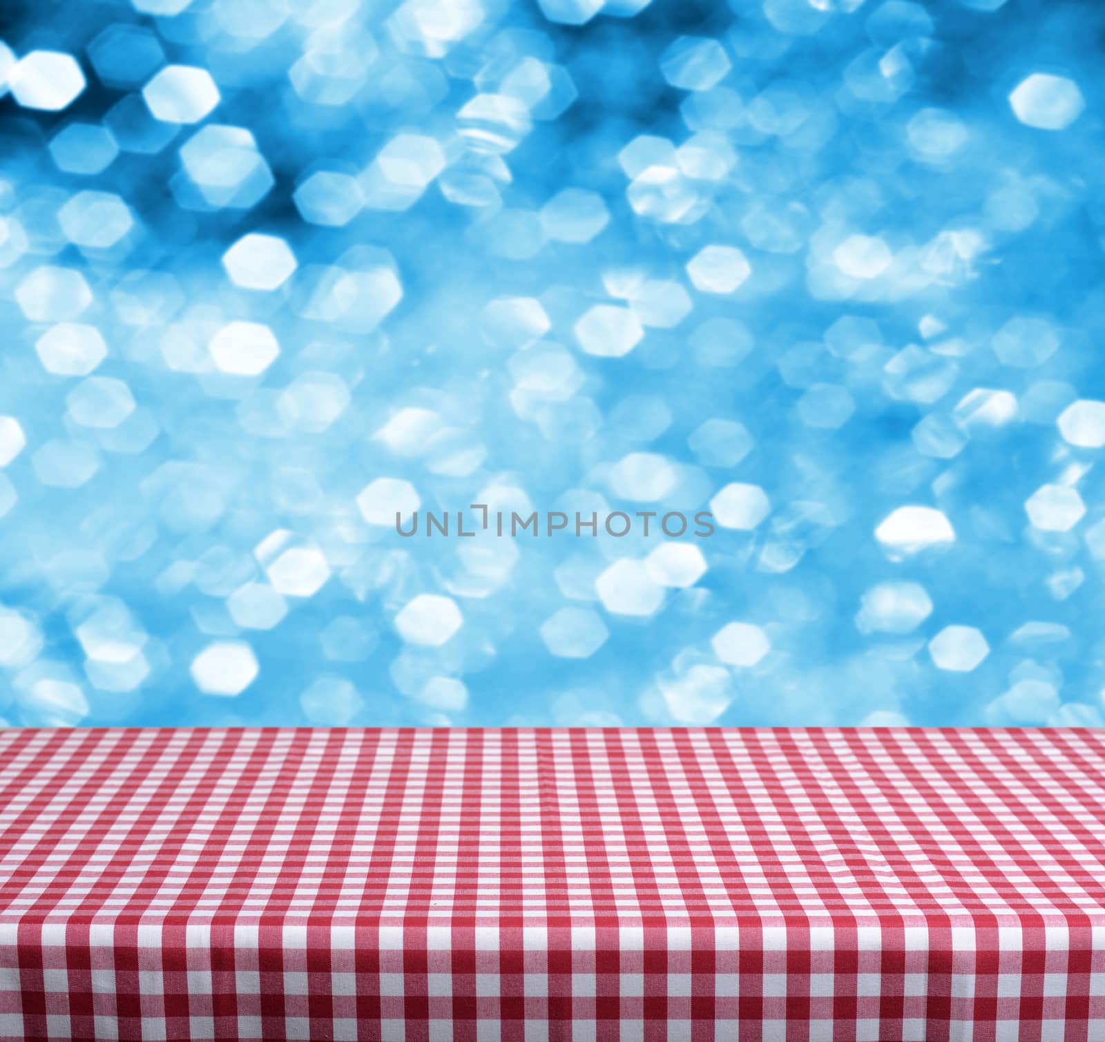 Empty wooden deck table with blue christmas background. Ready for product display montage.