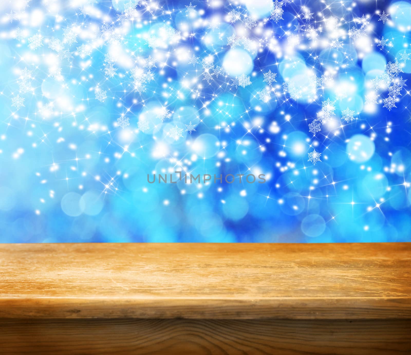 Empty wooden deck table with winter bokeh background. Ready for product display montage. 