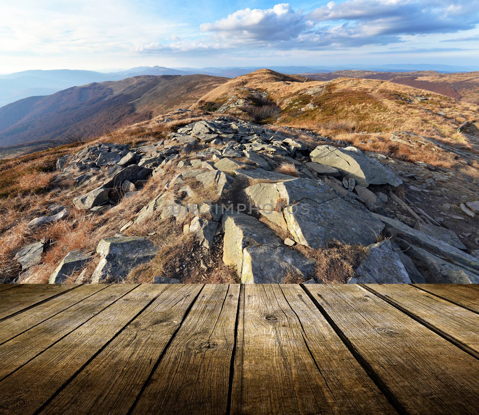 Empty wooden deck table with mountains background. Ready for product display montage. 