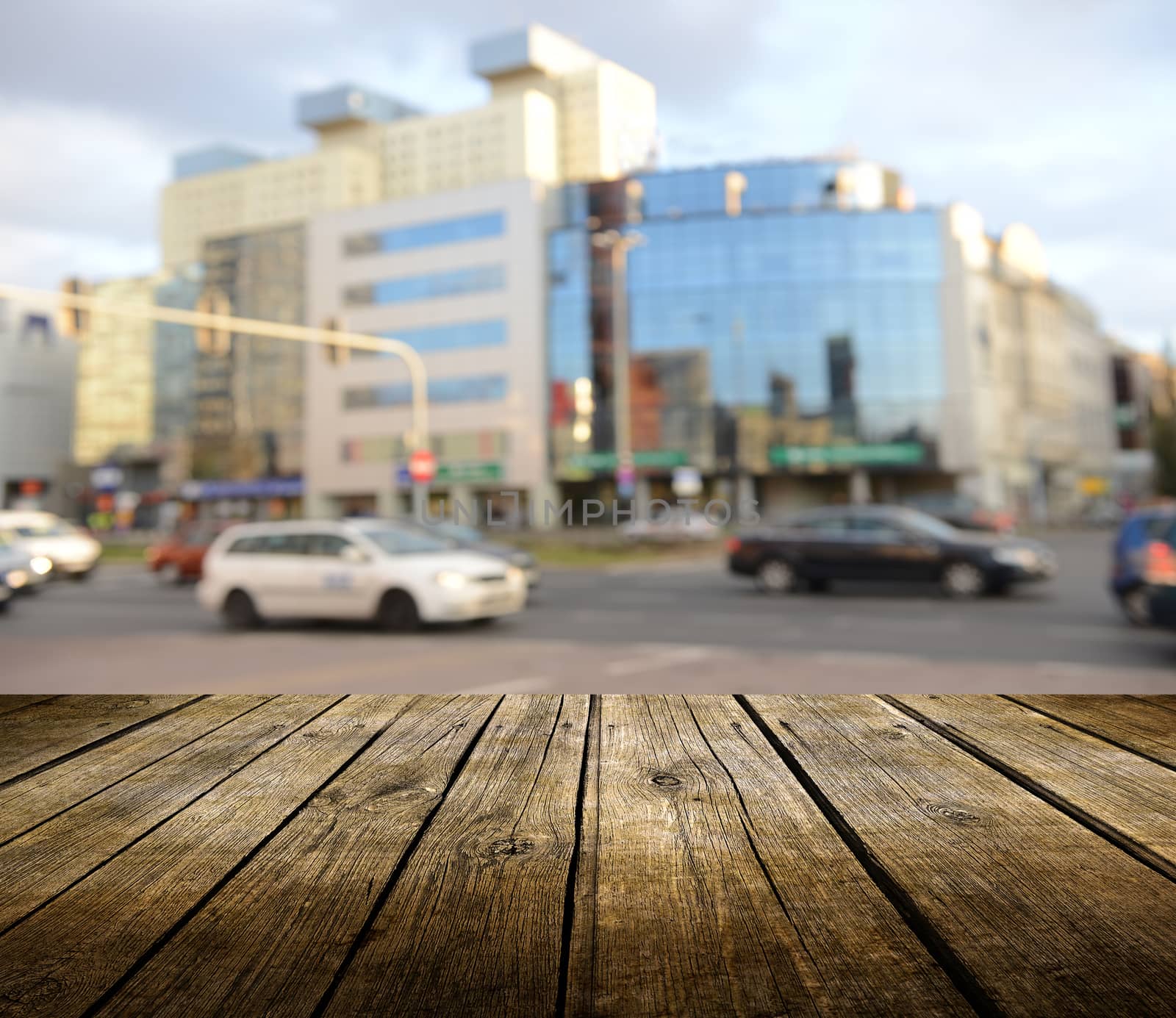 Empty wooden deck table with city in background. Ready for product display montage. 