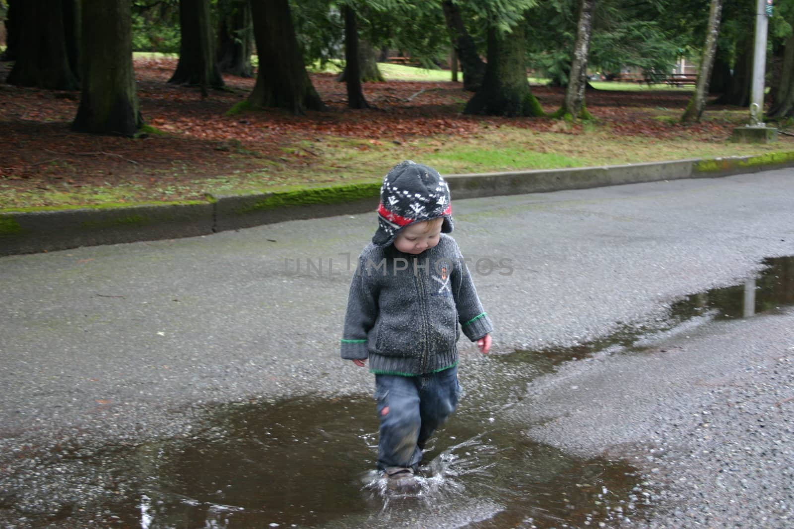 Boy stomping through puddles