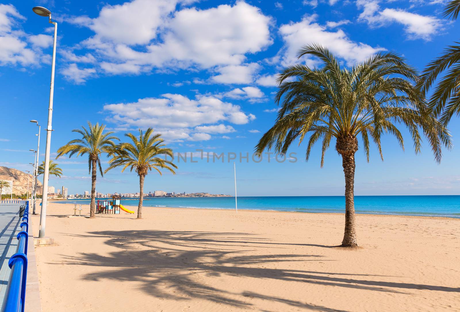 Alicante Postiguet beach at Mediterranean sea in Spain palm trees