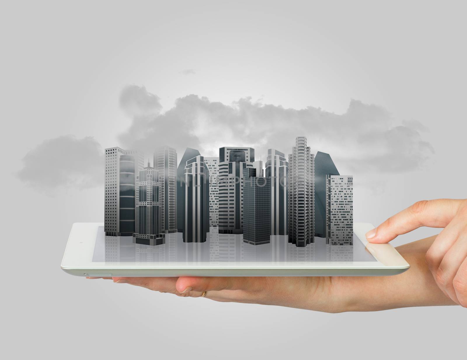 Hands holding a tablet computer. In screen tablet city of skyscrapers and smoke