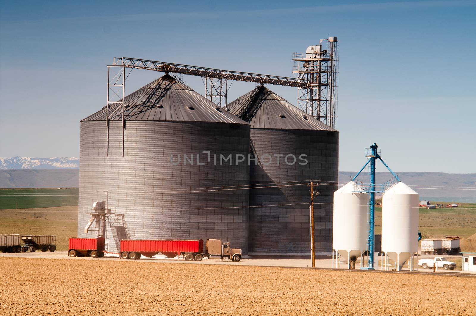 Agricultural Silo Loads Semi Truck With Farm Grown Food Grain by ChrisBoswell